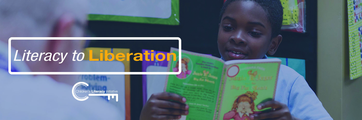 Literacy to Liberation Facebook banner - African American child reading book with teacher