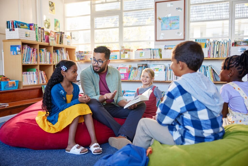 teacher reading with a diverse group of students